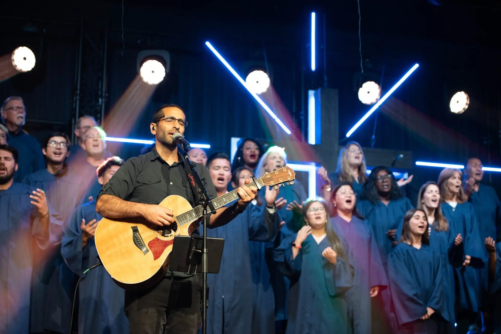 Alex Enfiedjian leading worship with a choir